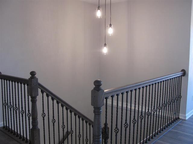 stairway with baseboards and wood finished floors