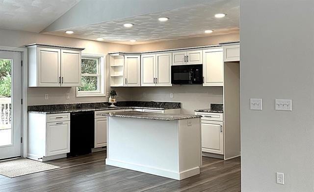 kitchen featuring black appliances, plenty of natural light, white cabinets, and a center island