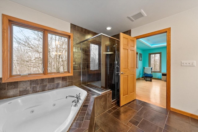 bathroom with a stall shower, visible vents, a whirlpool tub, and baseboards