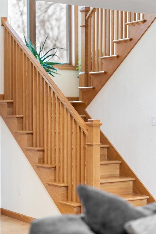 stairway with baseboards and wood finished floors