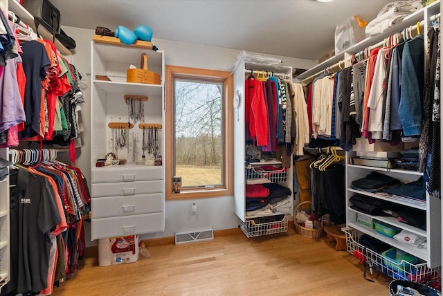 walk in closet featuring wood finished floors and visible vents