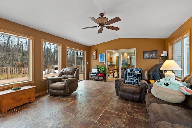 living area featuring lofted ceiling and a ceiling fan