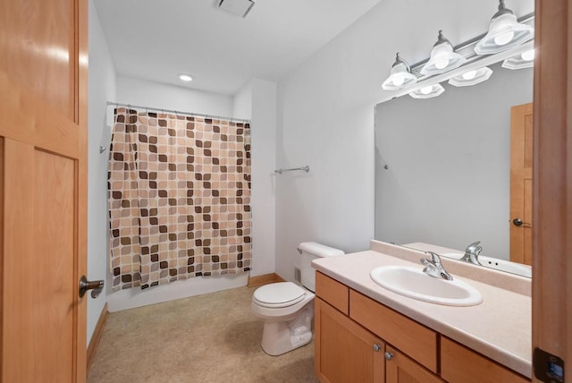 bathroom featuring toilet, vanity, and a shower with shower curtain