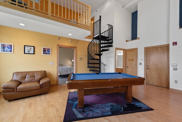 game room featuring recessed lighting, billiards, a towering ceiling, and wood finished floors