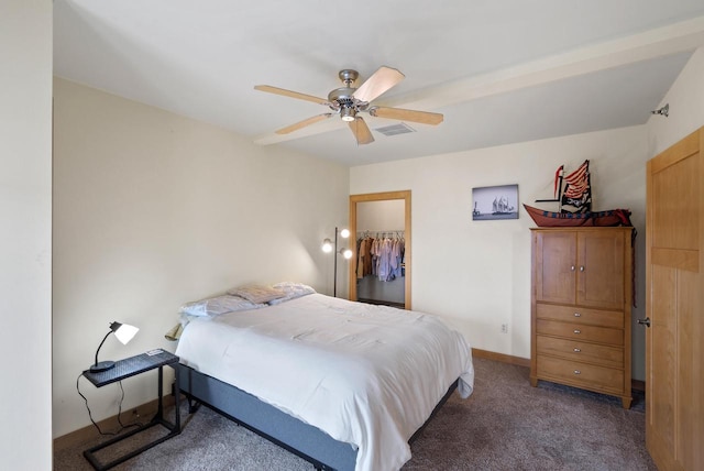 carpeted bedroom featuring a ceiling fan, visible vents, baseboards, a spacious closet, and a closet