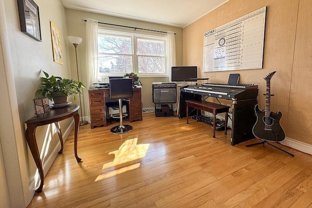 office area featuring light wood-type flooring and baseboards