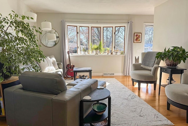 living area with light wood-type flooring and visible vents