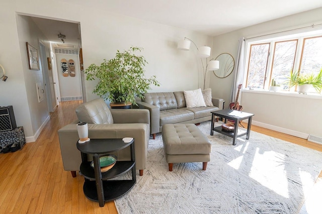 living room with light wood-style flooring and baseboards