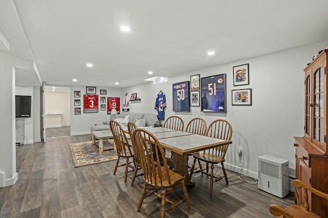 dining area with baseboards, wood finished floors, and recessed lighting