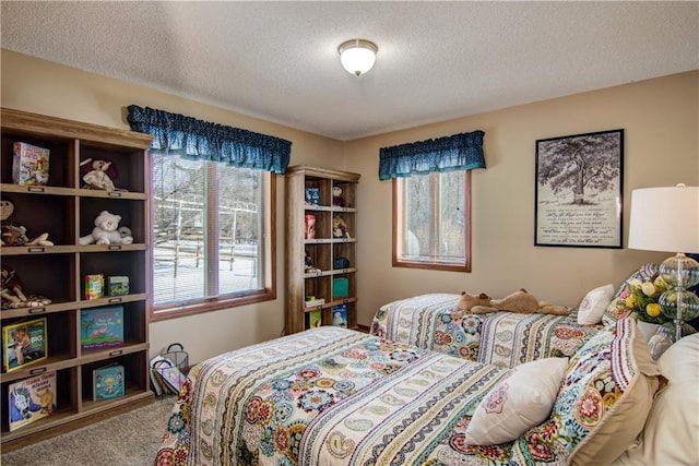 bedroom featuring a textured ceiling and carpet flooring