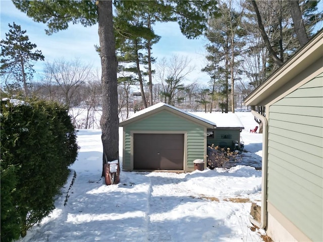 snow covered garage with a garage