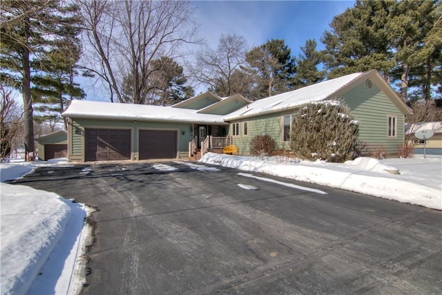 ranch-style house with driveway and an attached garage