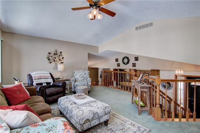 living area featuring lofted ceiling, a textured ceiling, ceiling fan with notable chandelier, visible vents, and carpet