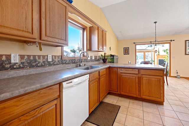 kitchen with light tile patterned floors, lofted ceiling, a peninsula, white dishwasher, and a sink