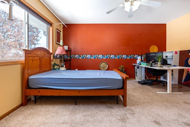 carpeted bedroom with ceiling fan and baseboards