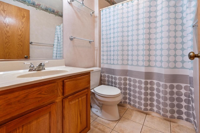 bathroom featuring toilet, a shower with curtain, vanity, and tile patterned floors