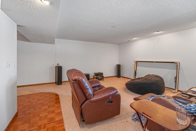 living room with a textured ceiling and baseboards