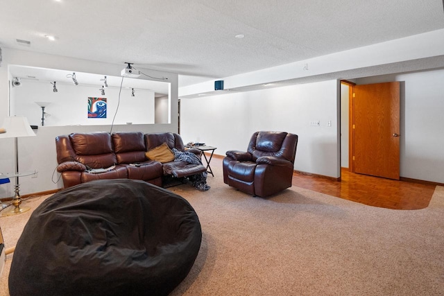 carpeted living room with a textured ceiling and baseboards