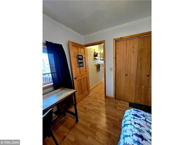 bedroom featuring light wood-type flooring and a closet