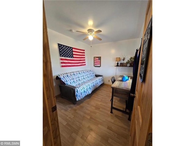 living area featuring ceiling fan and wood finished floors