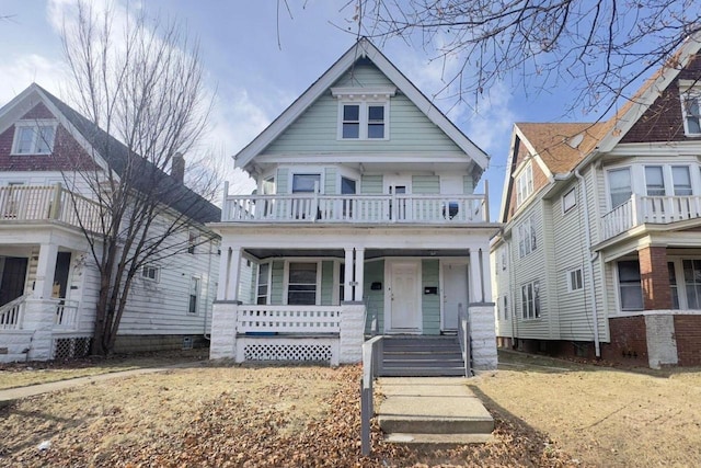 view of front of property featuring a balcony and a porch