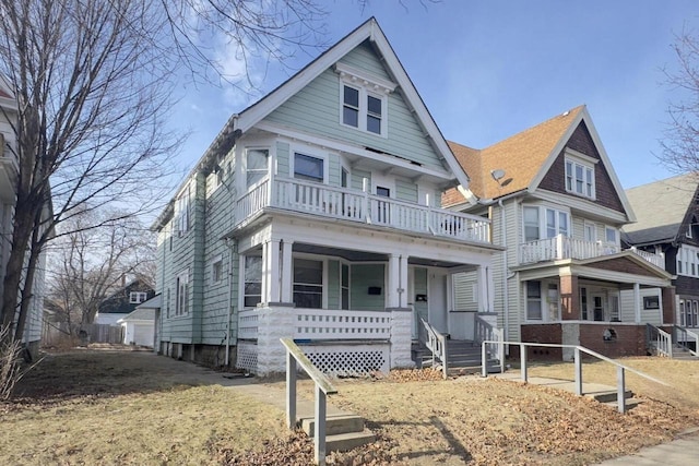 view of front of home with a balcony, covered porch, and a garage