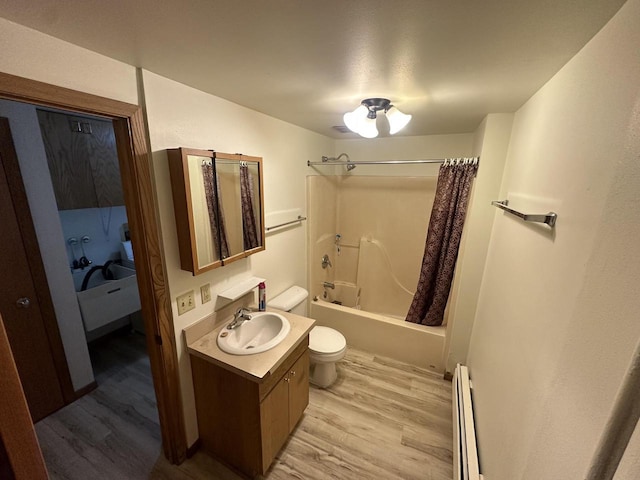 bathroom with toilet, a baseboard heating unit, shower / tub combo, wood finished floors, and vanity