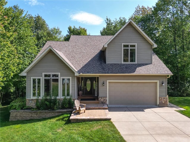 view of front of house with roof with shingles, concrete driveway, an attached garage, stone siding, and a front lawn