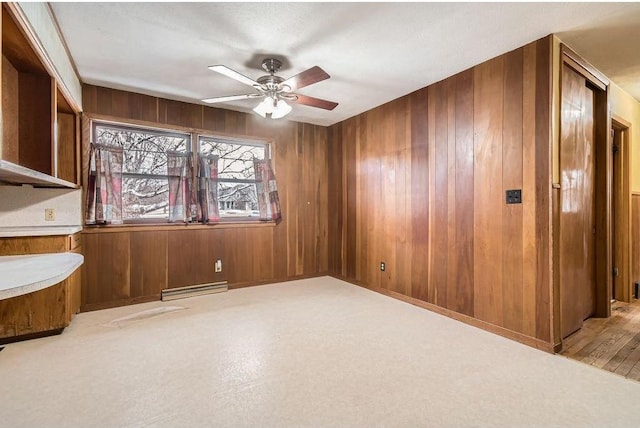 empty room with wooden walls and a ceiling fan