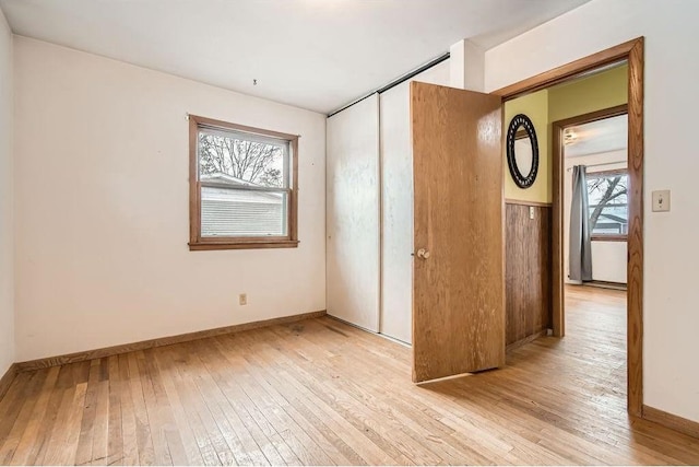 unfurnished bedroom featuring light wood finished floors and baseboards