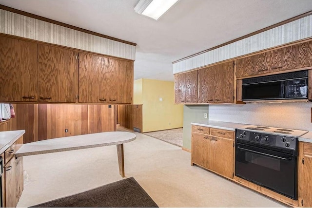 kitchen with wallpapered walls, brown cabinetry, light countertops, black microwave, and range with electric stovetop