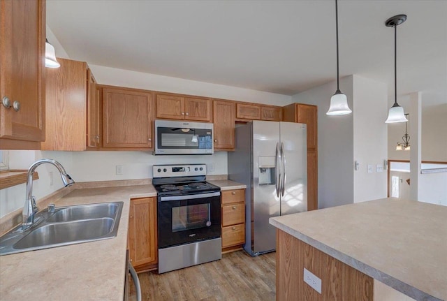 kitchen with light countertops, appliances with stainless steel finishes, and a sink