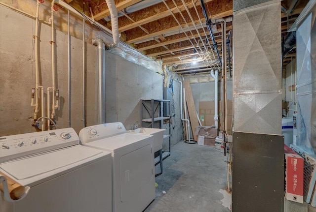 unfinished below grade area featuring heating unit and separate washer and dryer