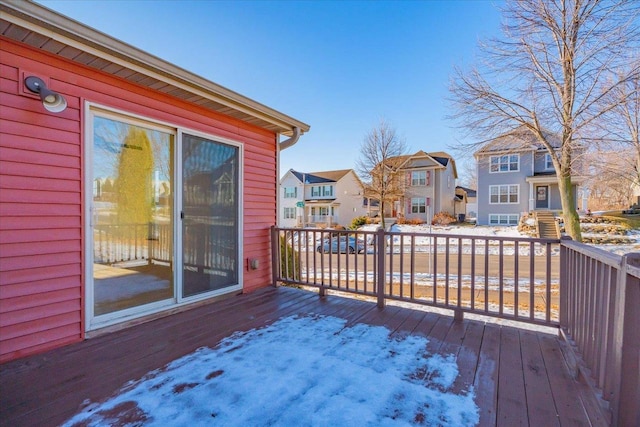 snow covered deck with a residential view