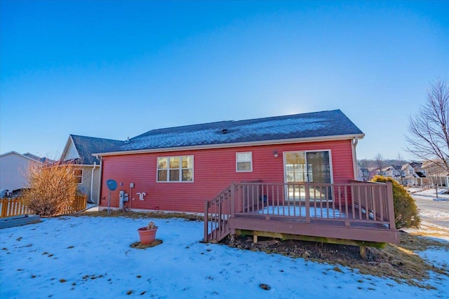 snow covered property featuring a deck