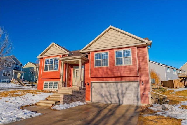 raised ranch featuring driveway and a garage
