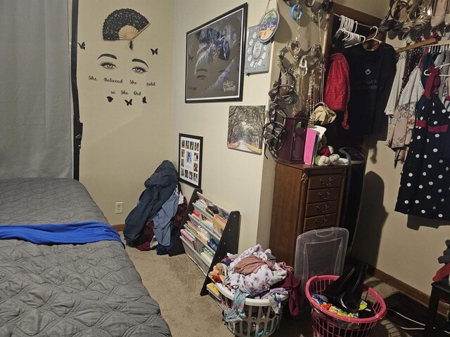 bedroom featuring carpet and baseboards