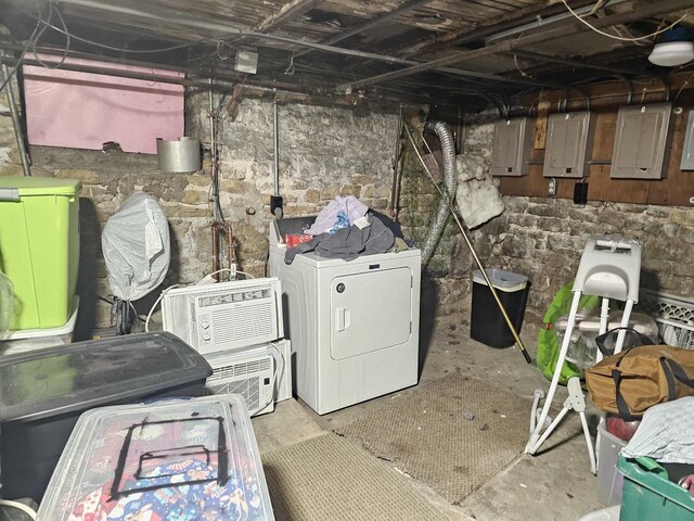 unfinished basement with electric panel and separate washer and dryer