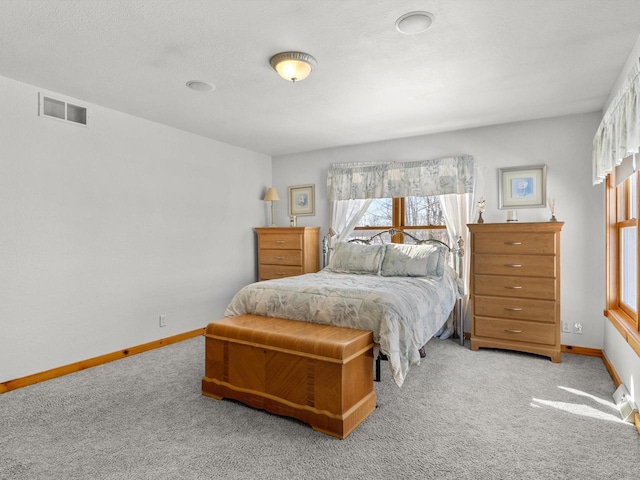 bedroom featuring light carpet, baseboards, and visible vents