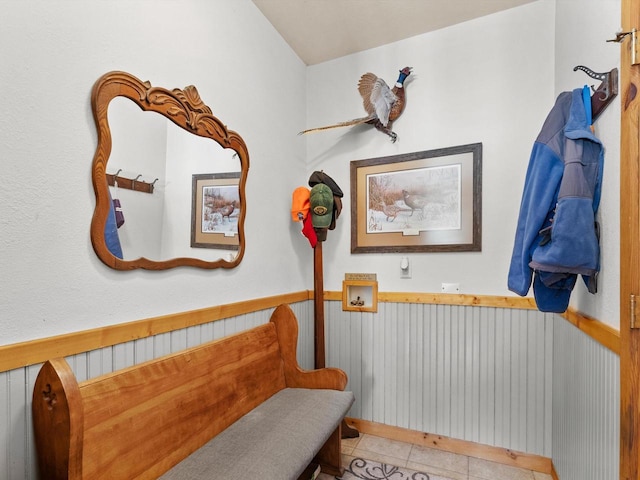 bathroom with wainscoting and tile patterned floors