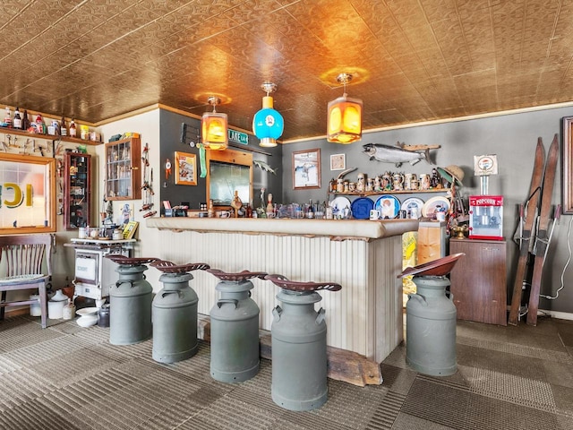 kitchen featuring hanging light fixtures, an ornate ceiling, and carpet flooring