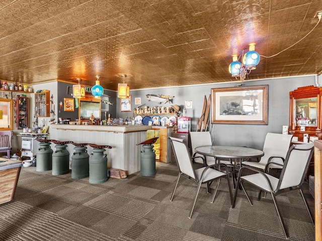 interior space with dark colored carpet, a bar, and an ornate ceiling