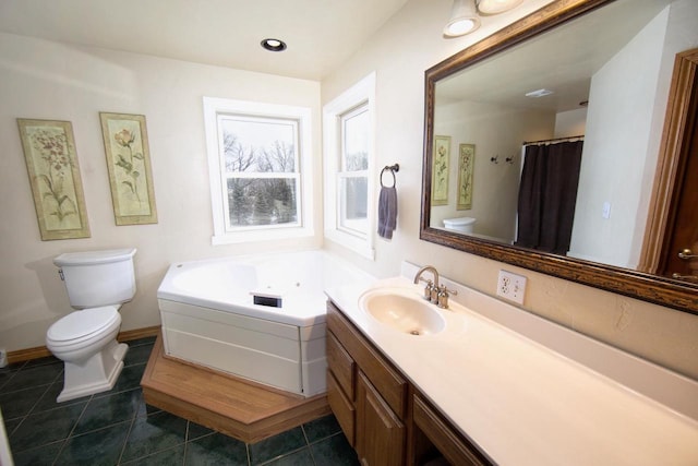 full bath featuring baseboards, toilet, tile patterned floors, vanity, and a bath