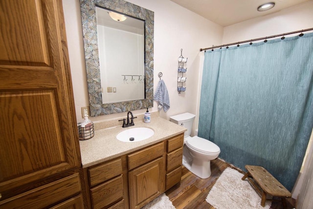 full bathroom featuring curtained shower, vanity, toilet, and wood finished floors