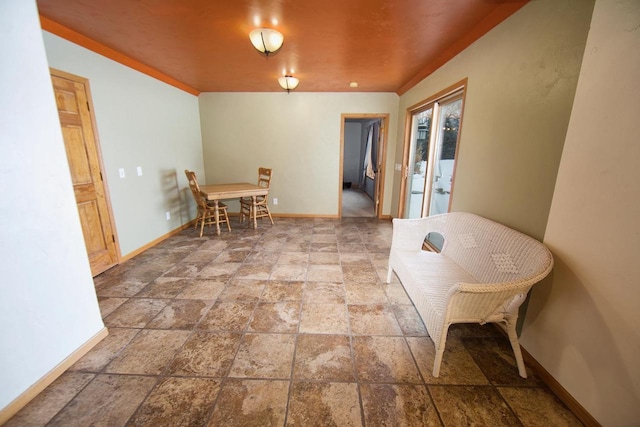 dining room with stone finish floor and baseboards