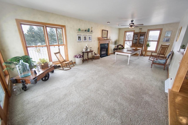 carpeted living room with a fireplace with flush hearth