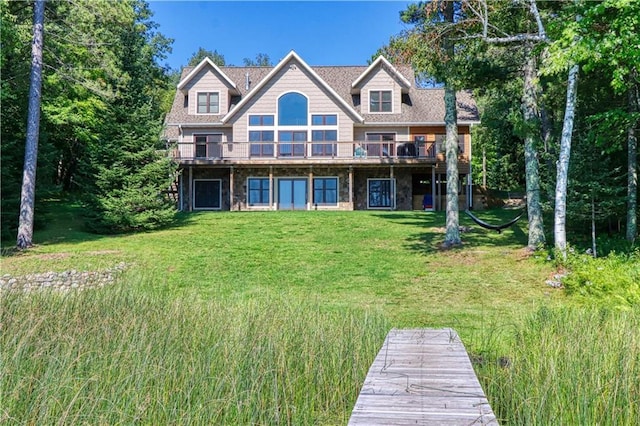 23310 Clam Lake Rd, Clam Lake, WI 54517 - rear view of house featuring stone siding, a yard, and a wooden deck