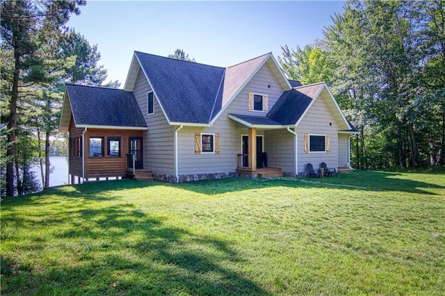 23310 Clam Lake Rd, Clam Lake, WI 54517 - view of front of property featuring a shingled roof and a front lawn