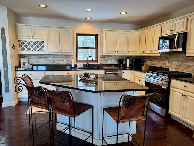 23310 Clam Lake Rd, Clam Lake, WI 54517 - kitchen featuring dark wood finished floors, a kitchen island, stainless steel appliances, and a sink
