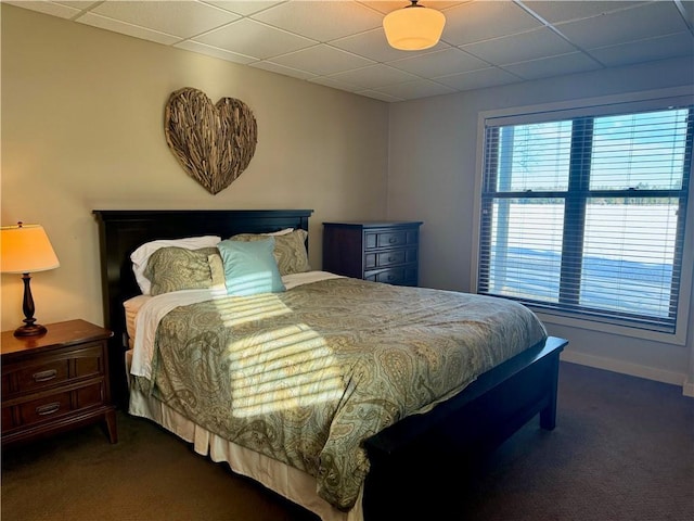 23310 Clam Lake Rd, Clam Lake, WI 54517 - bedroom with baseboards, dark colored carpet, and a drop ceiling